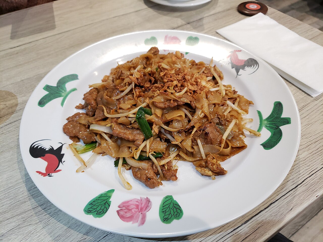 Beef chow fun plate context for checking Cantonese noodle texture and sheen