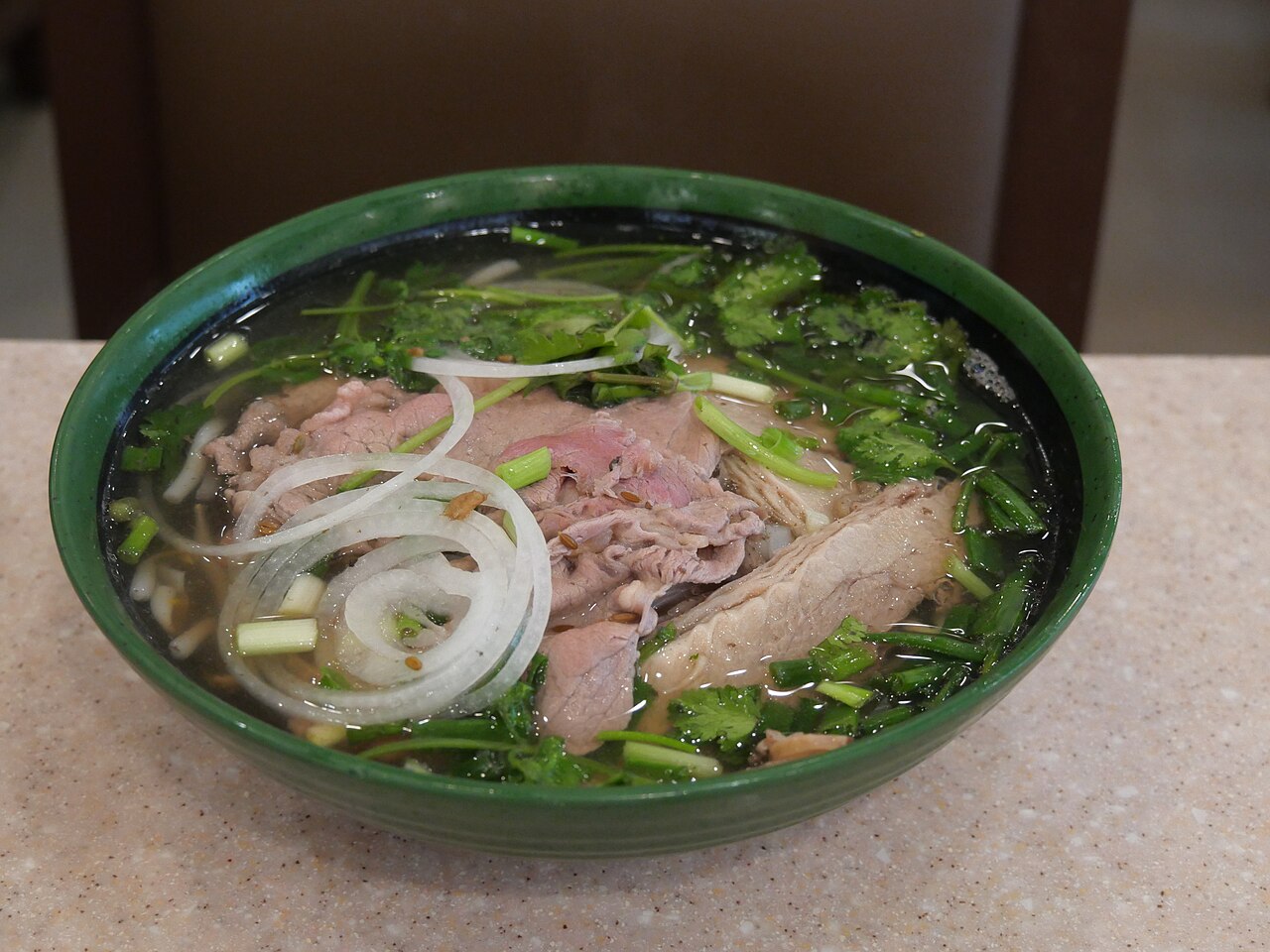 Wide rice noodle preparation context for beef chow fun recipe with noodles, wok, and cooking tools