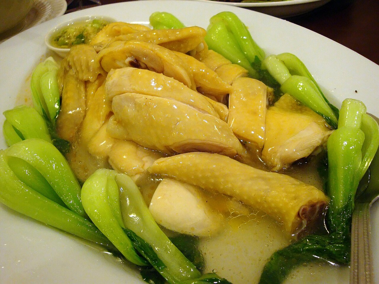 Steamed chicken preparation context for checking timing, aromatics, and gentle heat