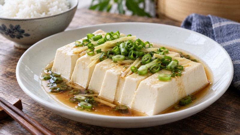 Finished steamed tofu with light soy dressing and scallion