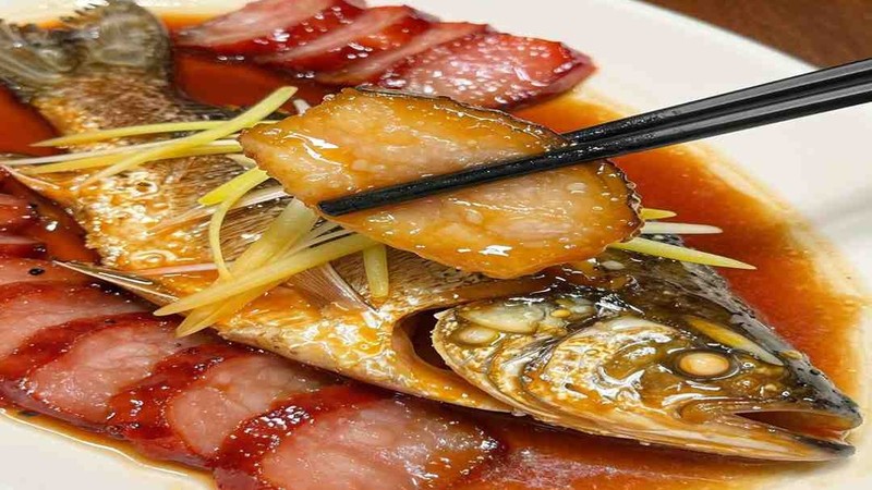 Whole fish and roast pork on a platter