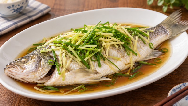 Whole ginger-scallion fish on a serving plate