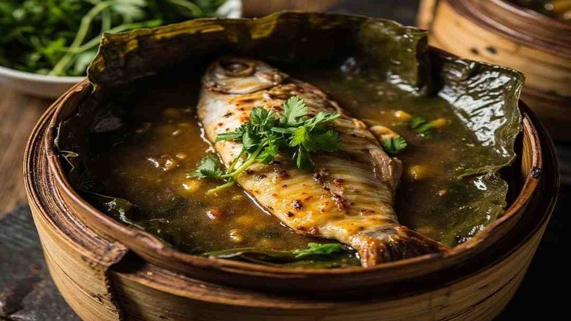 Fish served on an opened banana leaf in a steaming basket
