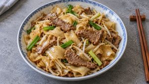 Dry beef chow fun with glossy wide flat noodles and no pooled gravy