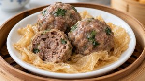 Steamed beef balls with coriander and a visible bean-curd base
