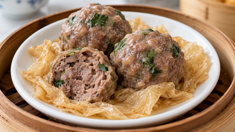 Steamed beef balls with coriander and a visible bean-curd base