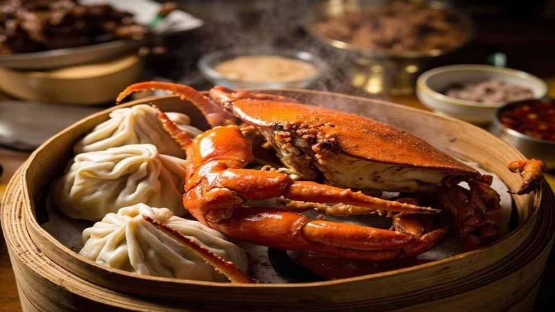 A cooked crab beside dumplings in a bamboo vessel
