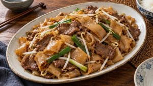 Dry-style beef chow fun with wide flat rice noodles and scallions