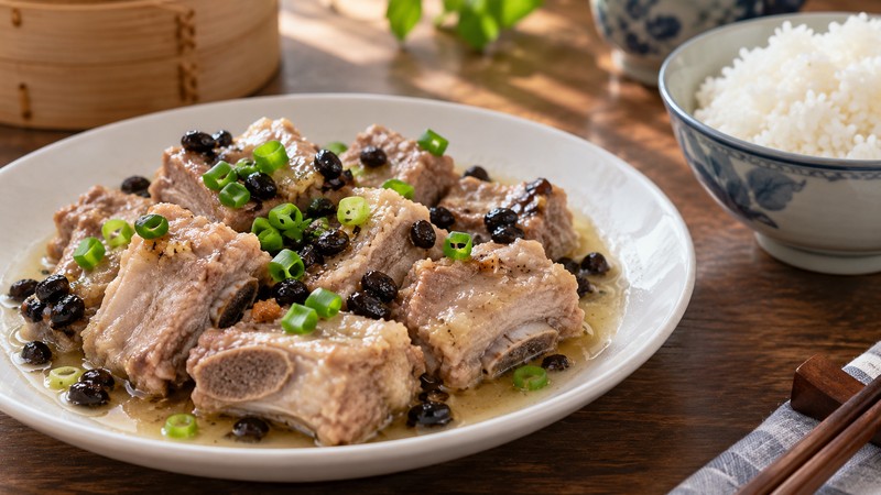 Steamed spare ribs with black beans and scallion in a shallow plate