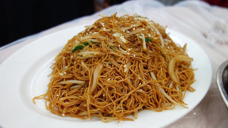 Thin stir-fried egg noodles on a white plate