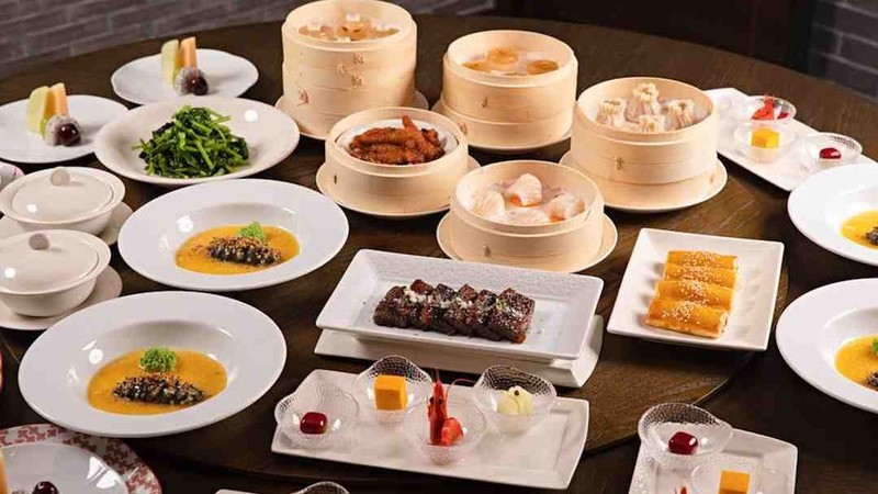 Dim sum dishes and bamboo steamer baskets on a table