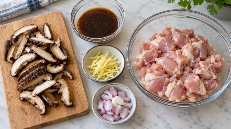 Softened shiitake mushrooms sliced beside evenly cut chicken and a small marinade bowl