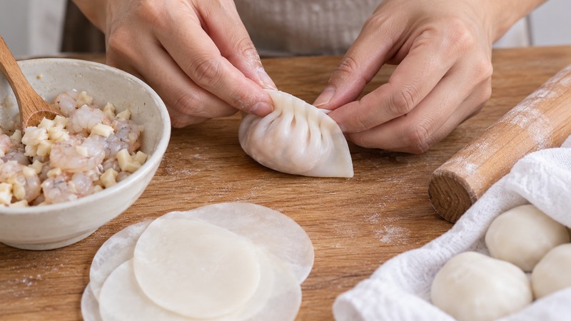 A starch wrapper pleated around shrimp filling