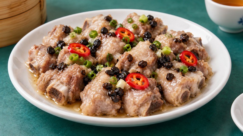 Small steamed pork rib pieces with black beans and scallion garnish