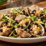 Finished Cantonese steamed clams with garlic, fermented black beans, ginger, and scallions